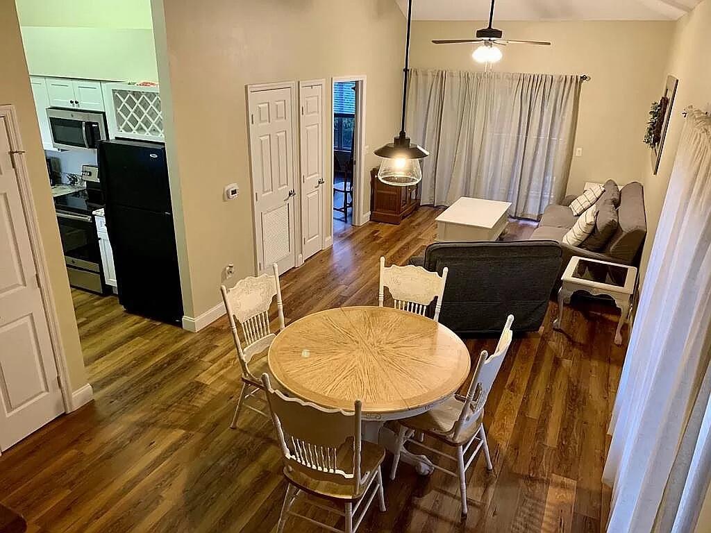 a view of a dining room with furniture and wooden floor