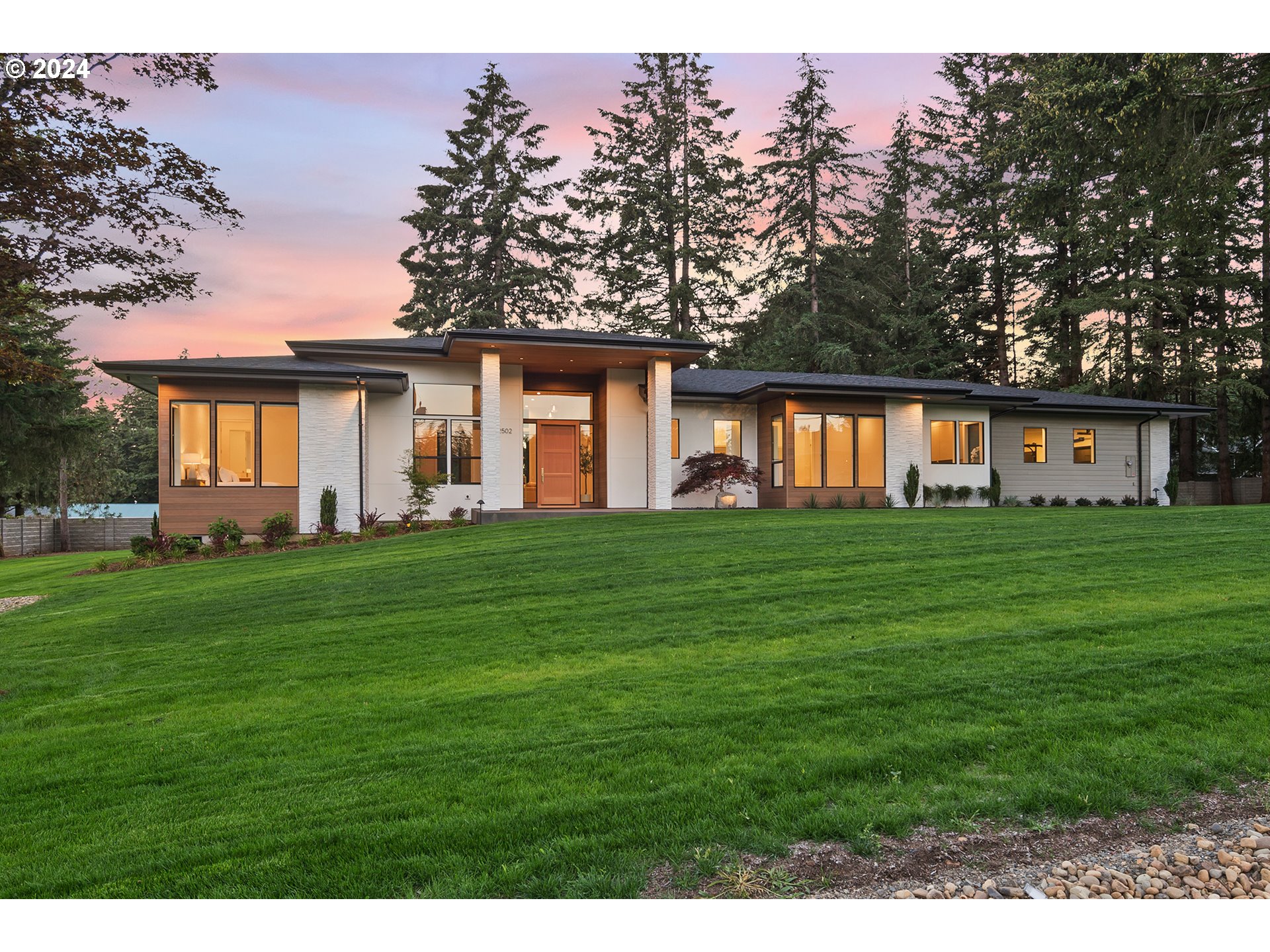 a front view of house with yard and green space