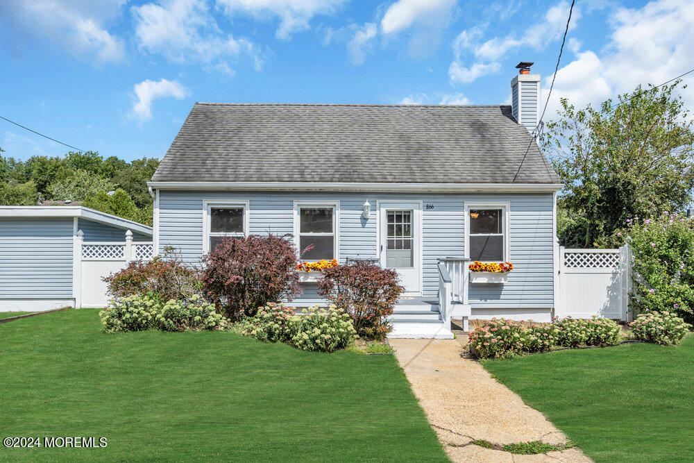 a front view of house with yard and green space