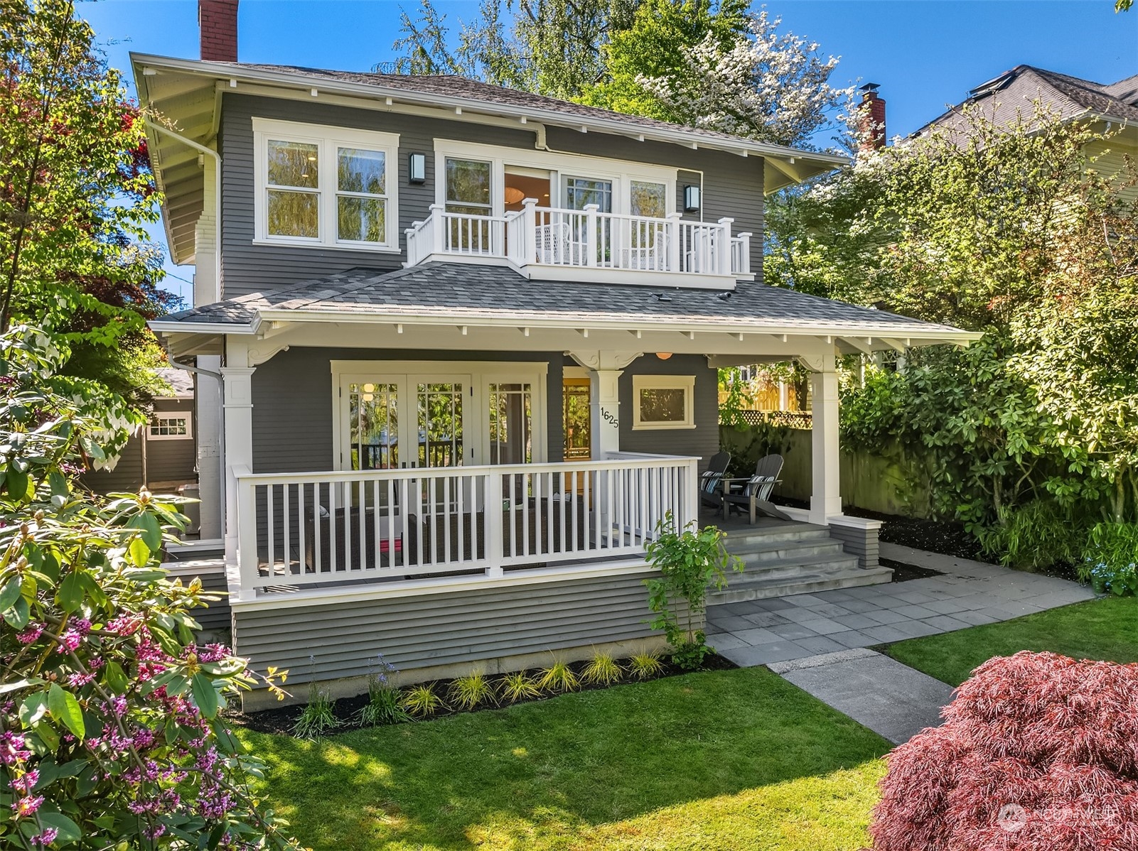 a view of a house with a yard and a garden