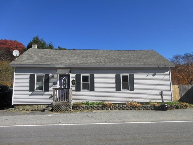 a front view of a house with a garden and garage