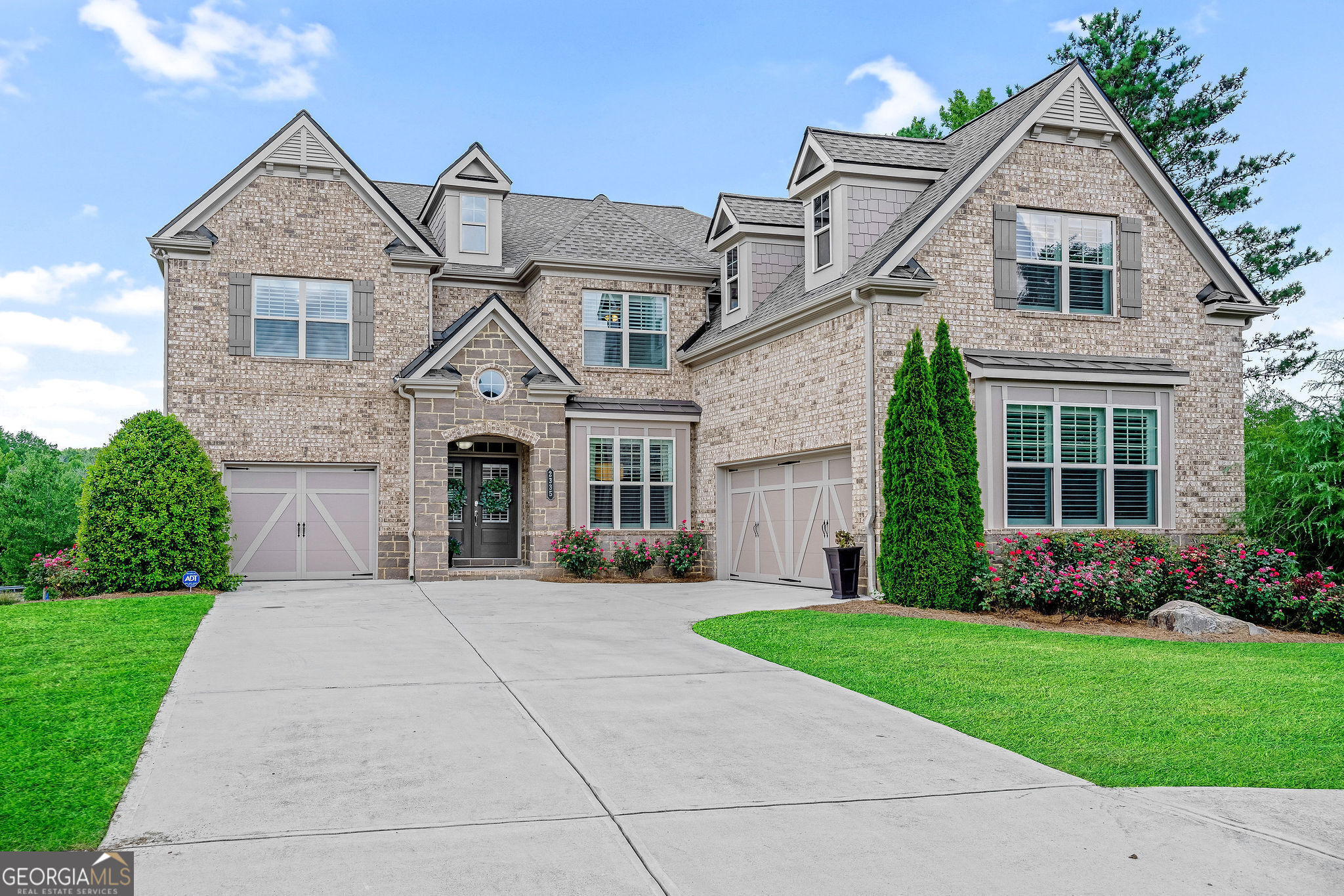 a front view of a house with garden