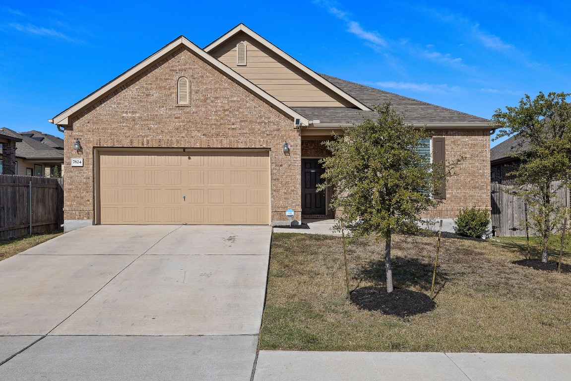 a front view of house with garage and yard