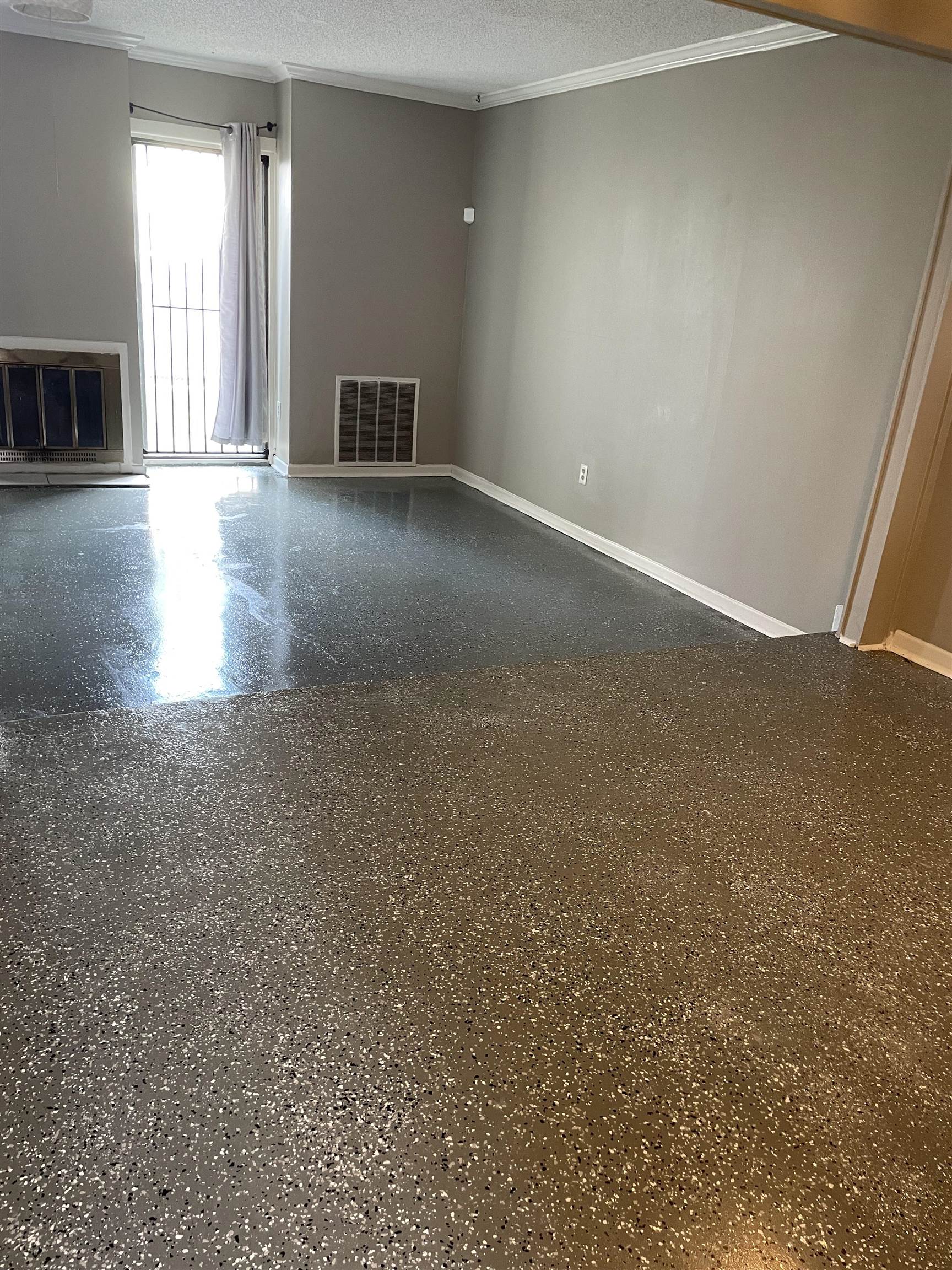 Empty room with a textured ceiling and crown molding