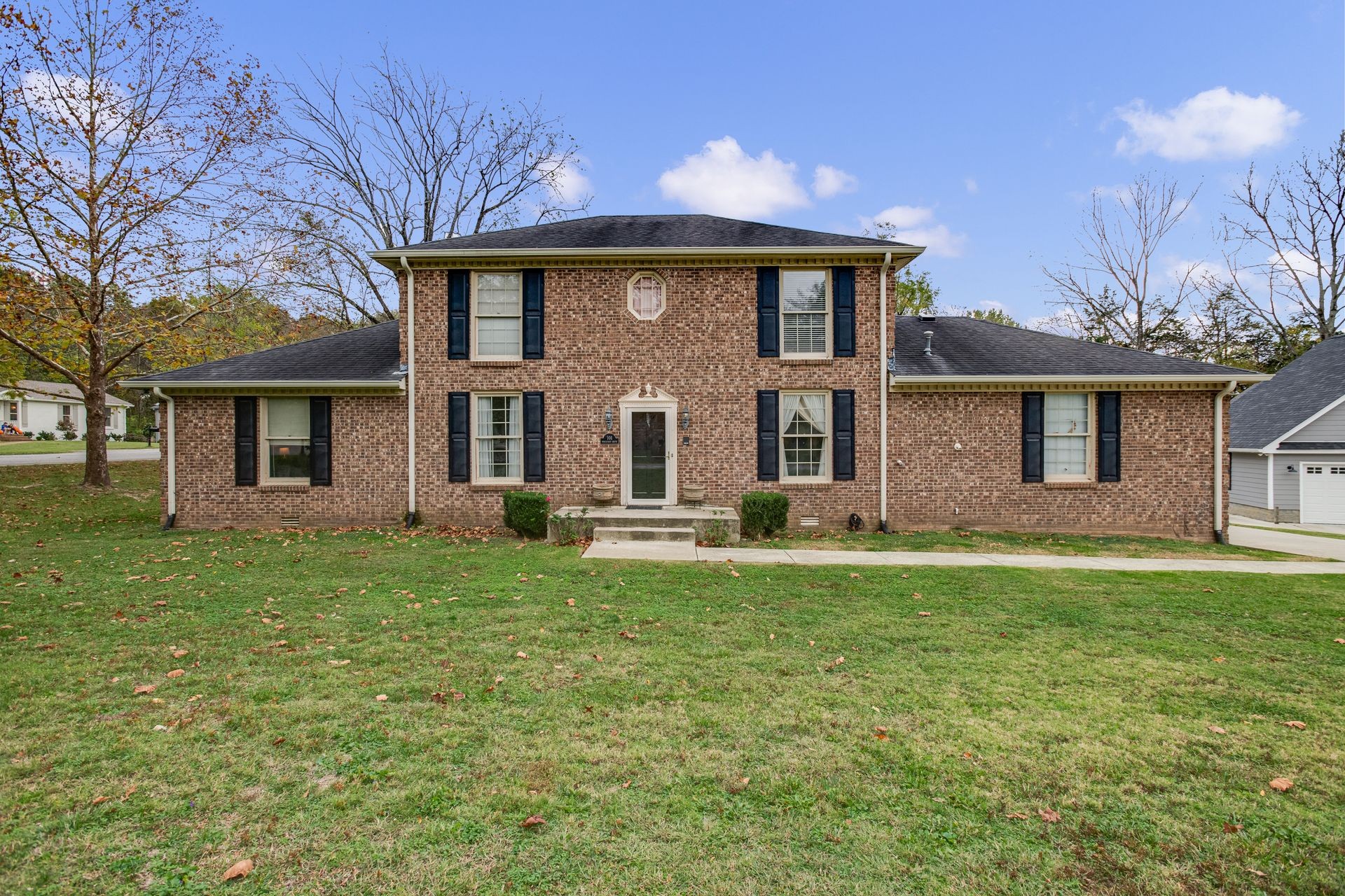 a front view of a house with a garden