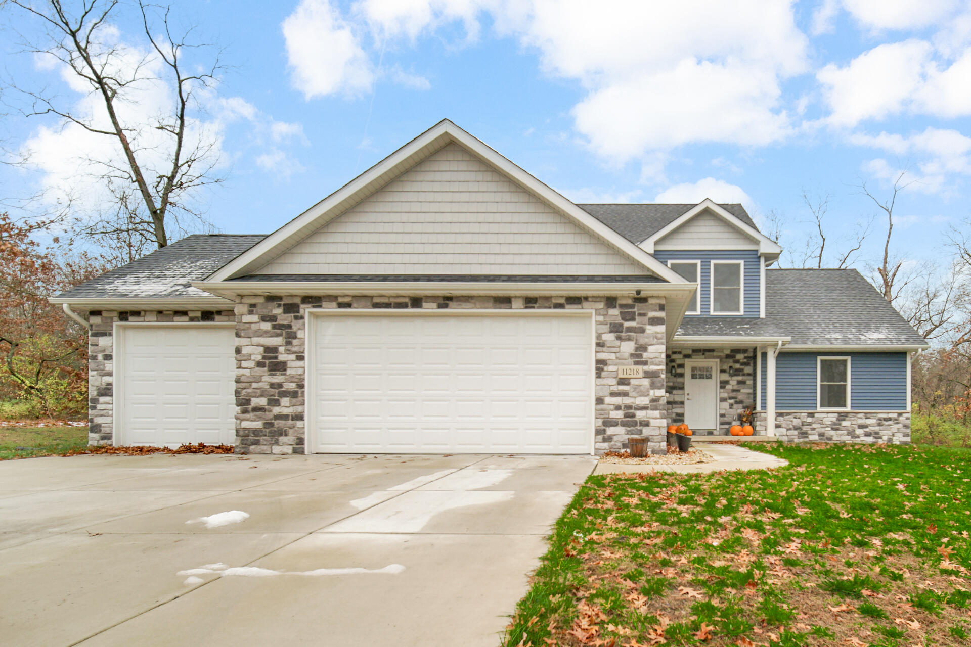 a front view of a house with a yard and garage