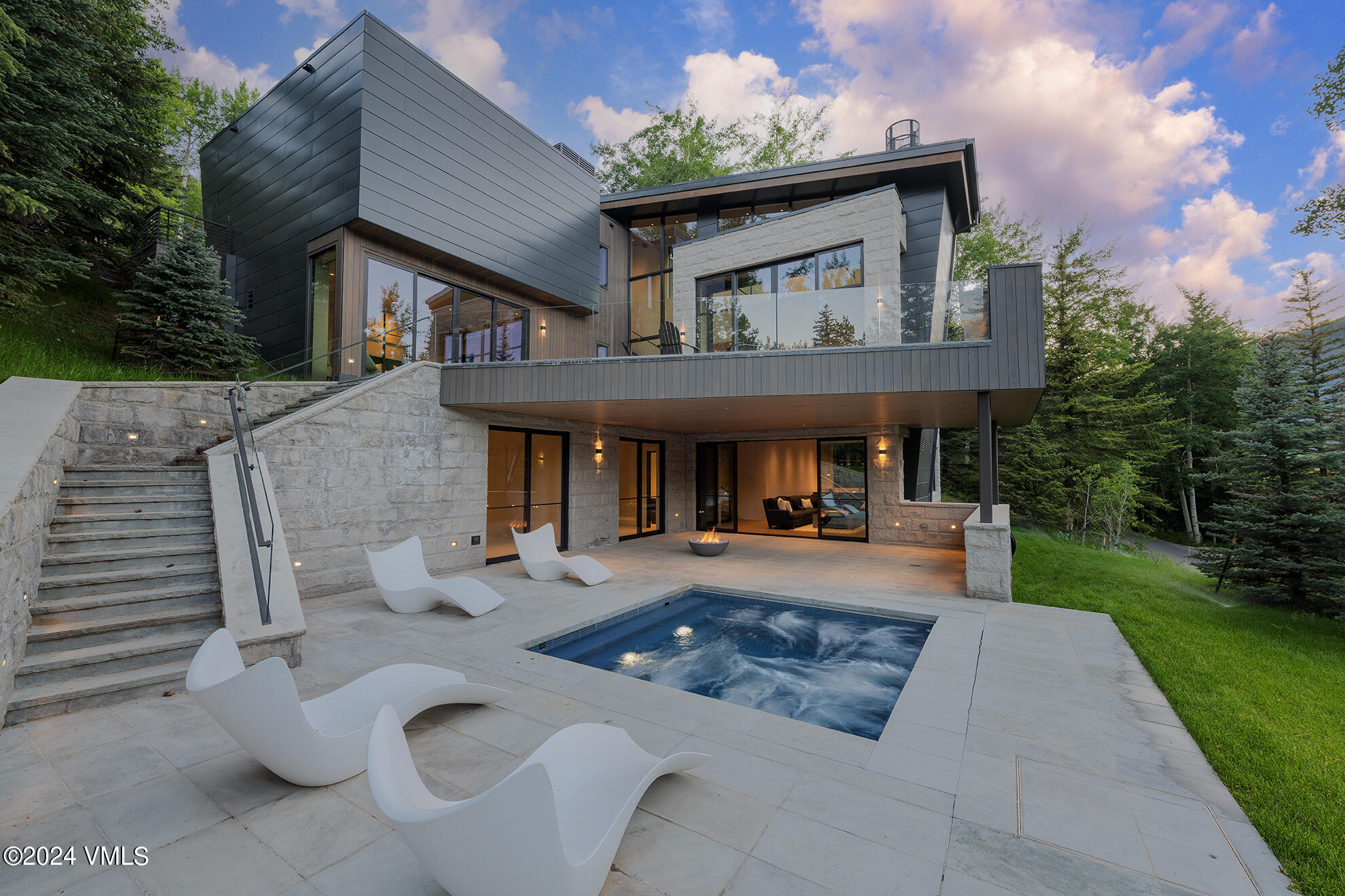 a front view of a house with patio furniture and garden