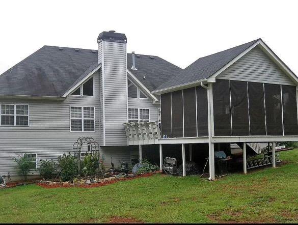 a view of a house with yard and sitting area