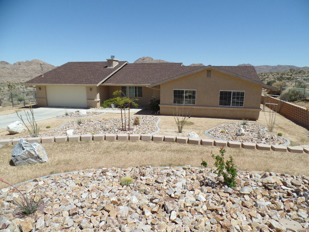 a view of a house with a yard covered with snow