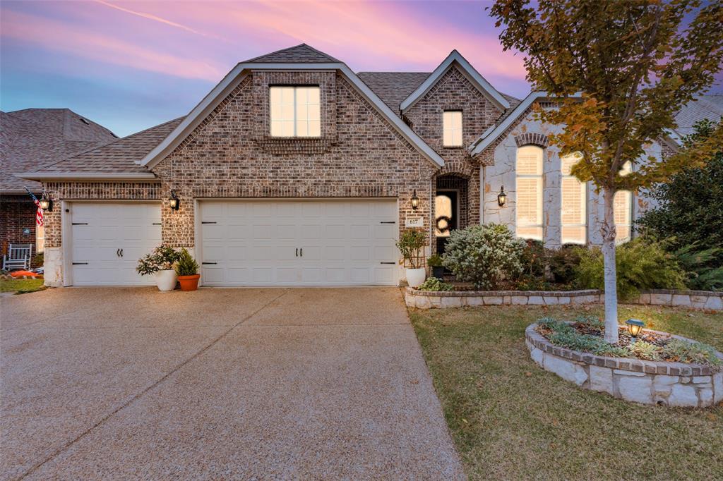 a front view of a house with a yard garage and garage