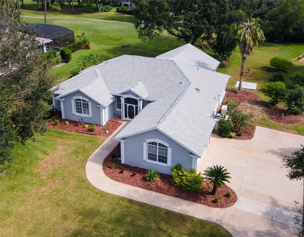 an aerial view of a house with a yard