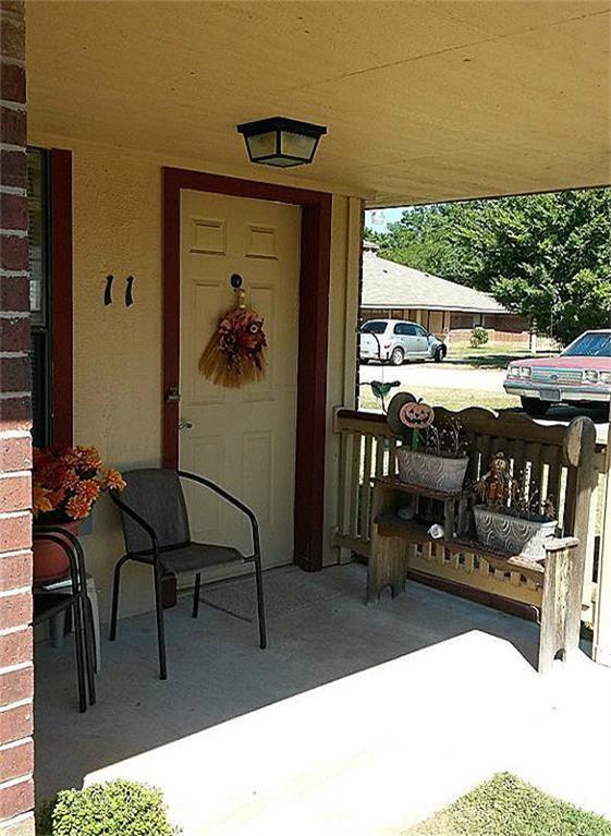 a view of a porch with chairs and a table