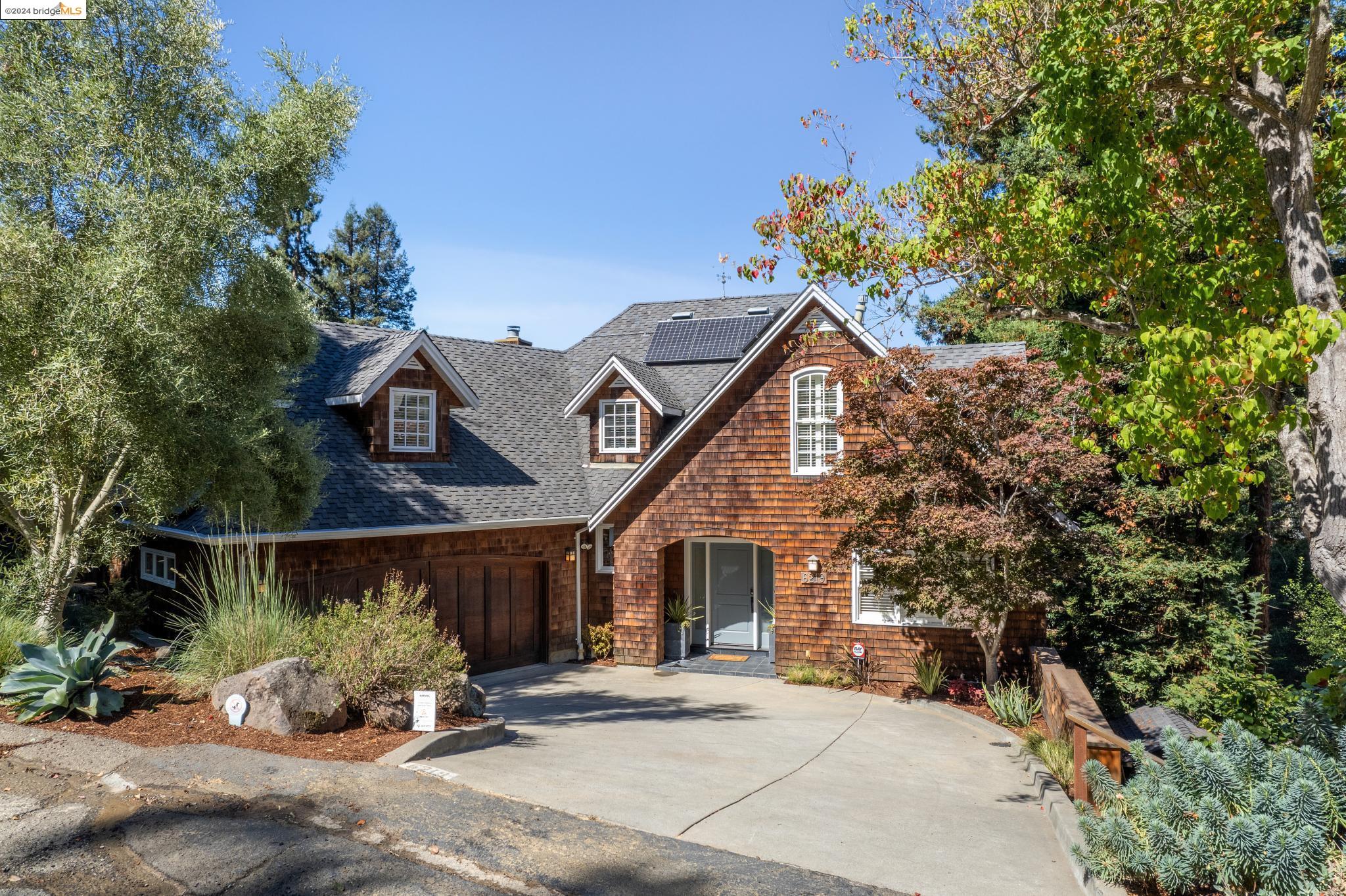 a view of a house with a tree in front of it