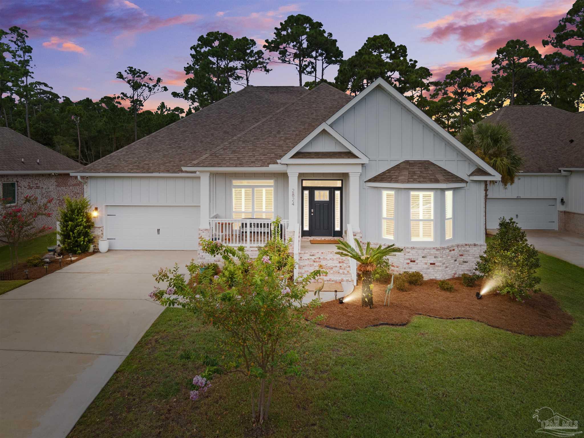 a front view of a house with a garden