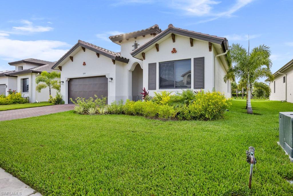 a front view of a house with a yard and garage