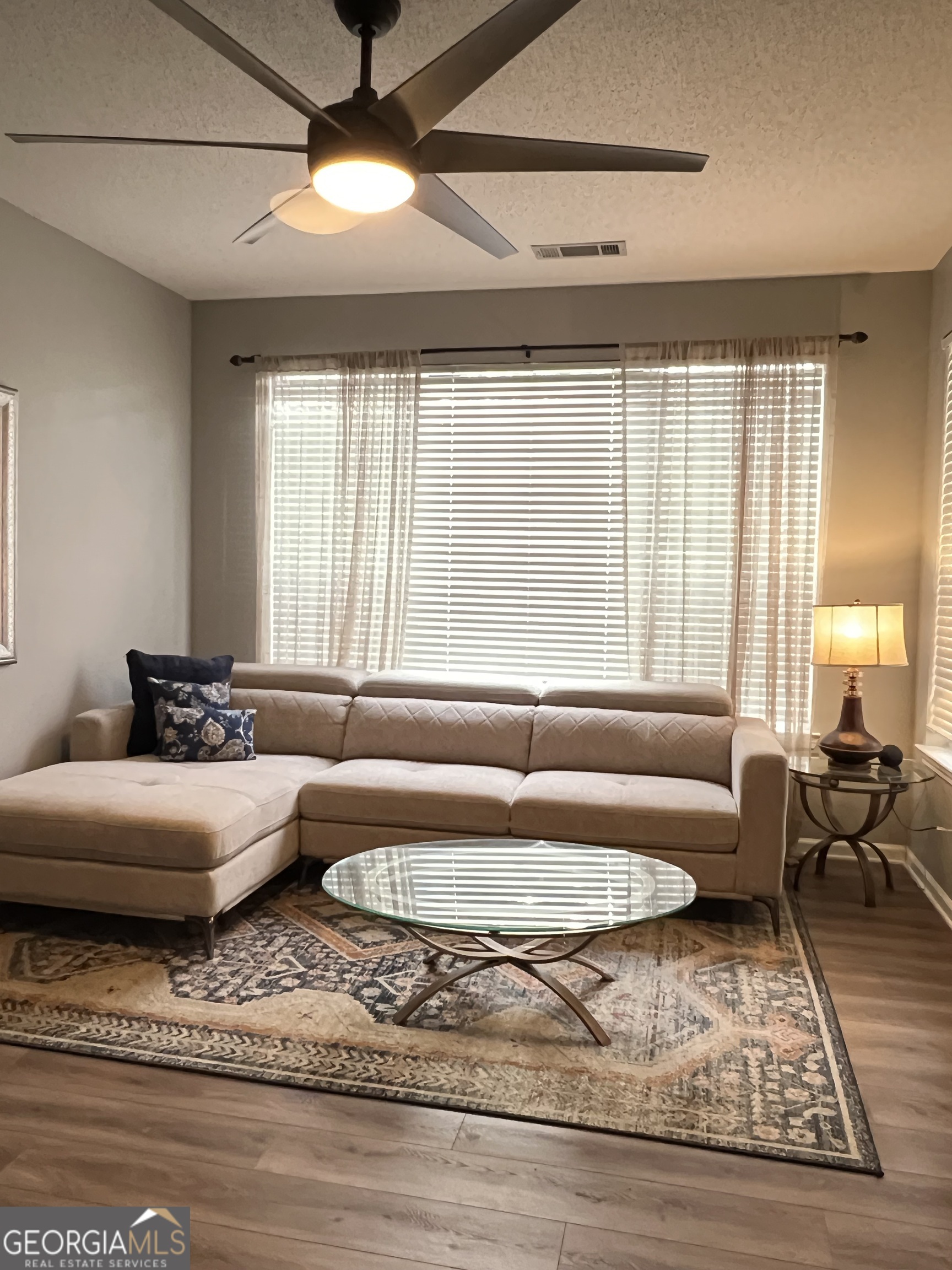 a living room with furniture and a rug