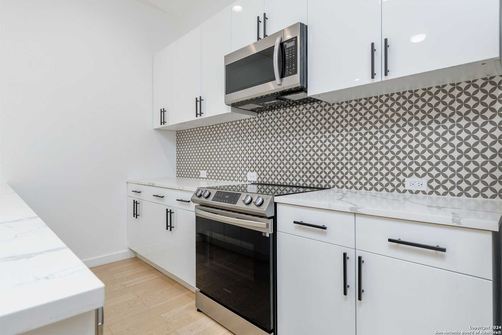 a kitchen with a stove and a microwave