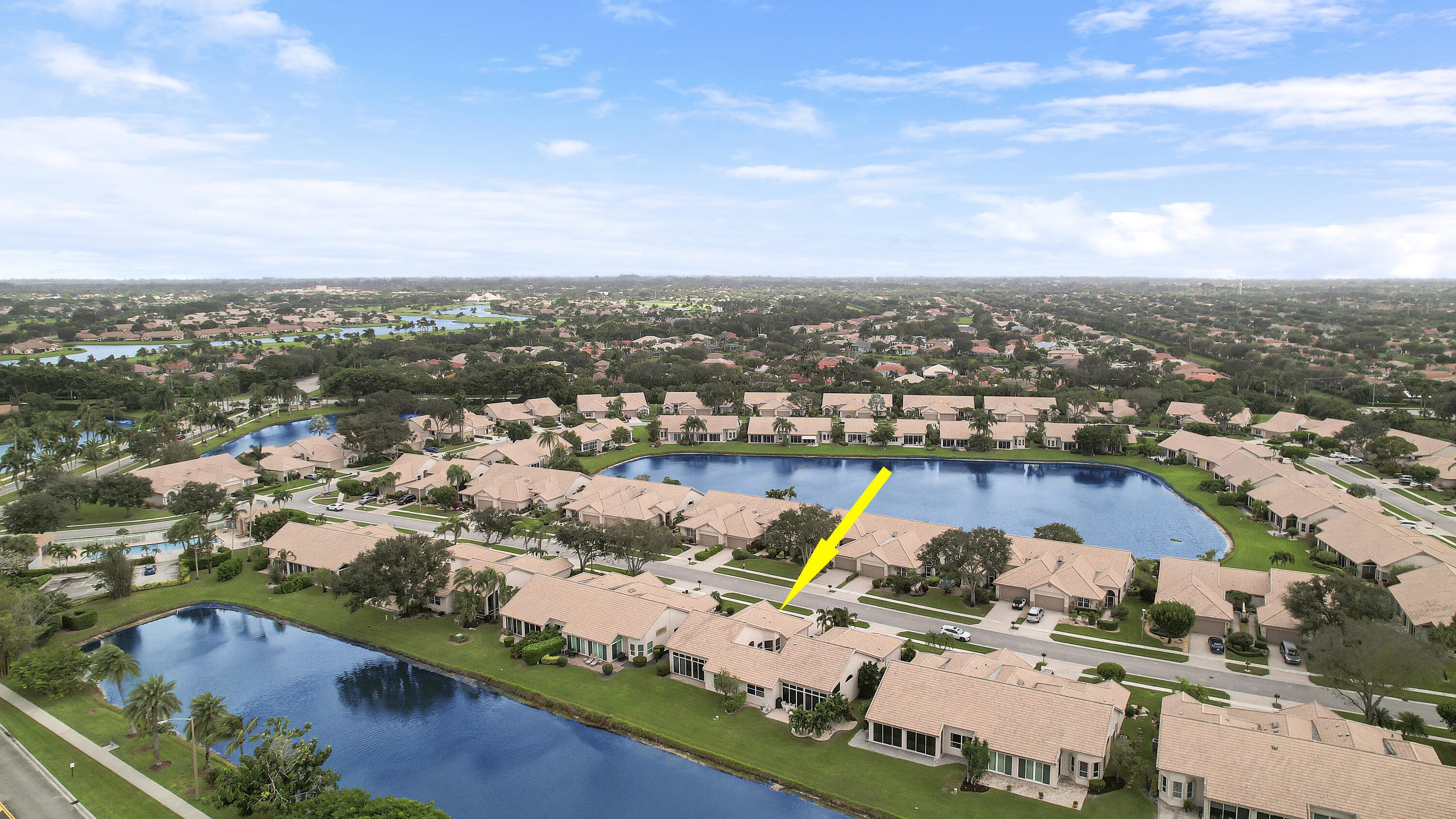 an aerial view of a houses with a swimming pool