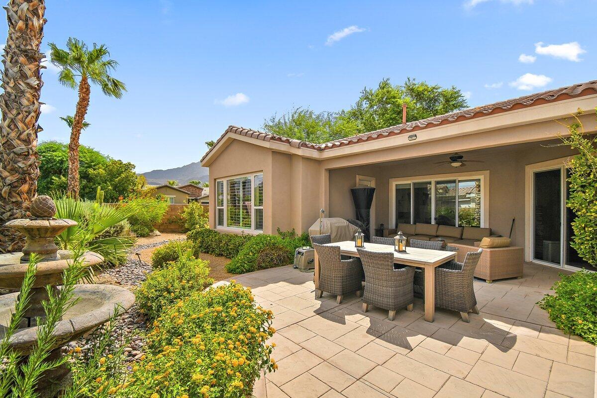 a view of a patio with table and chairs and potted plants