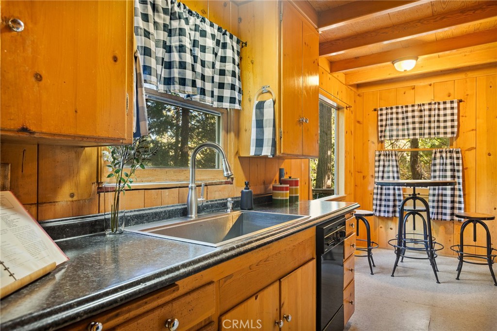 a view of a kitchen with granite countertop a sink and a counter top space