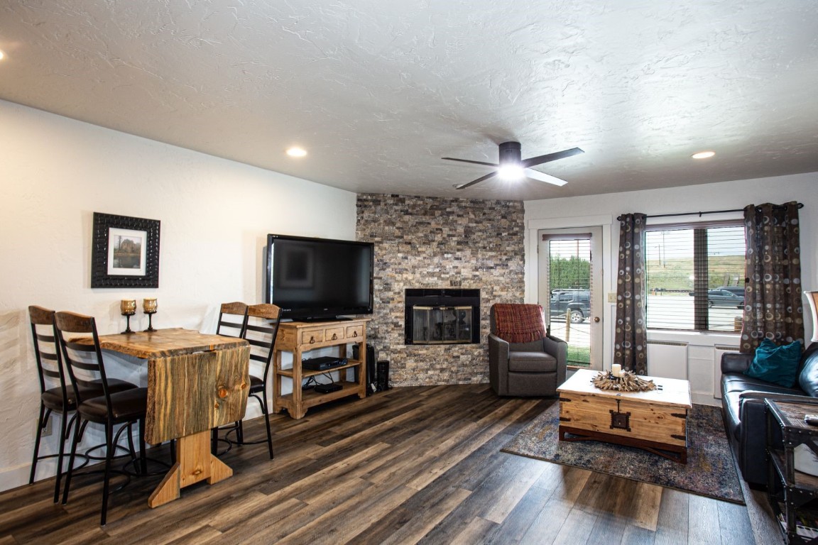 a living room with fireplace furniture and a flat screen tv