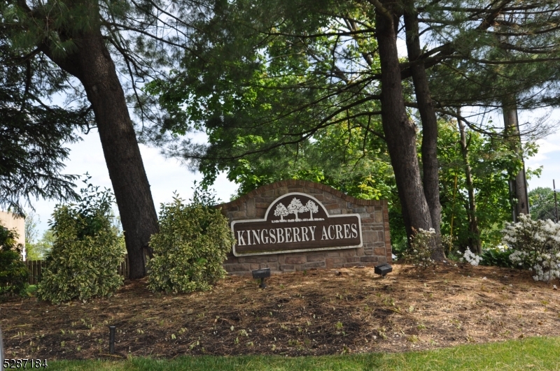 a view of a street sign under a large tree