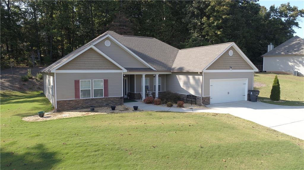 a front view of a house with a yard and garage