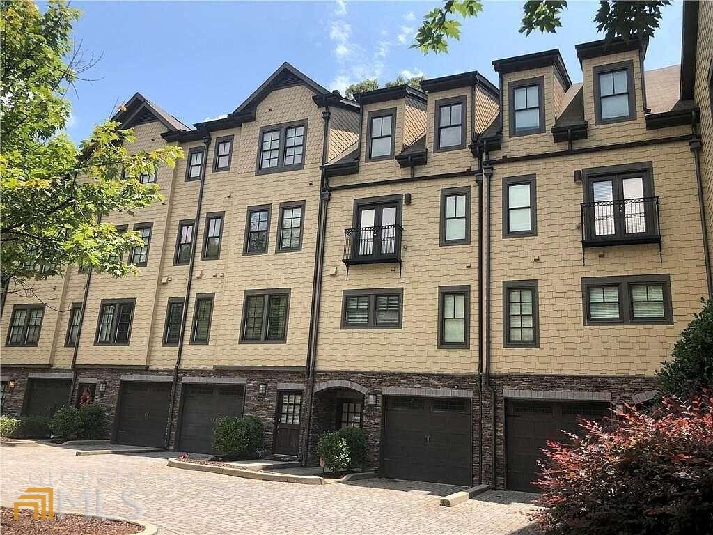 a front view of a residential apartment building with a yard