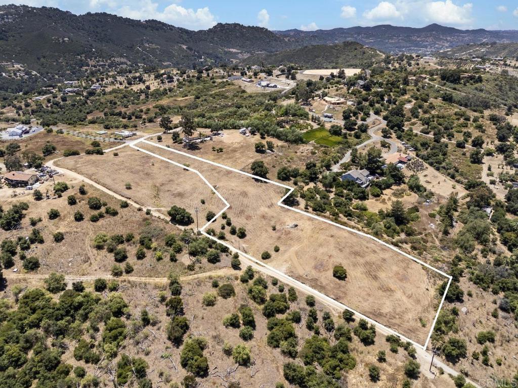 an aerial view of residential house and sandy dunes