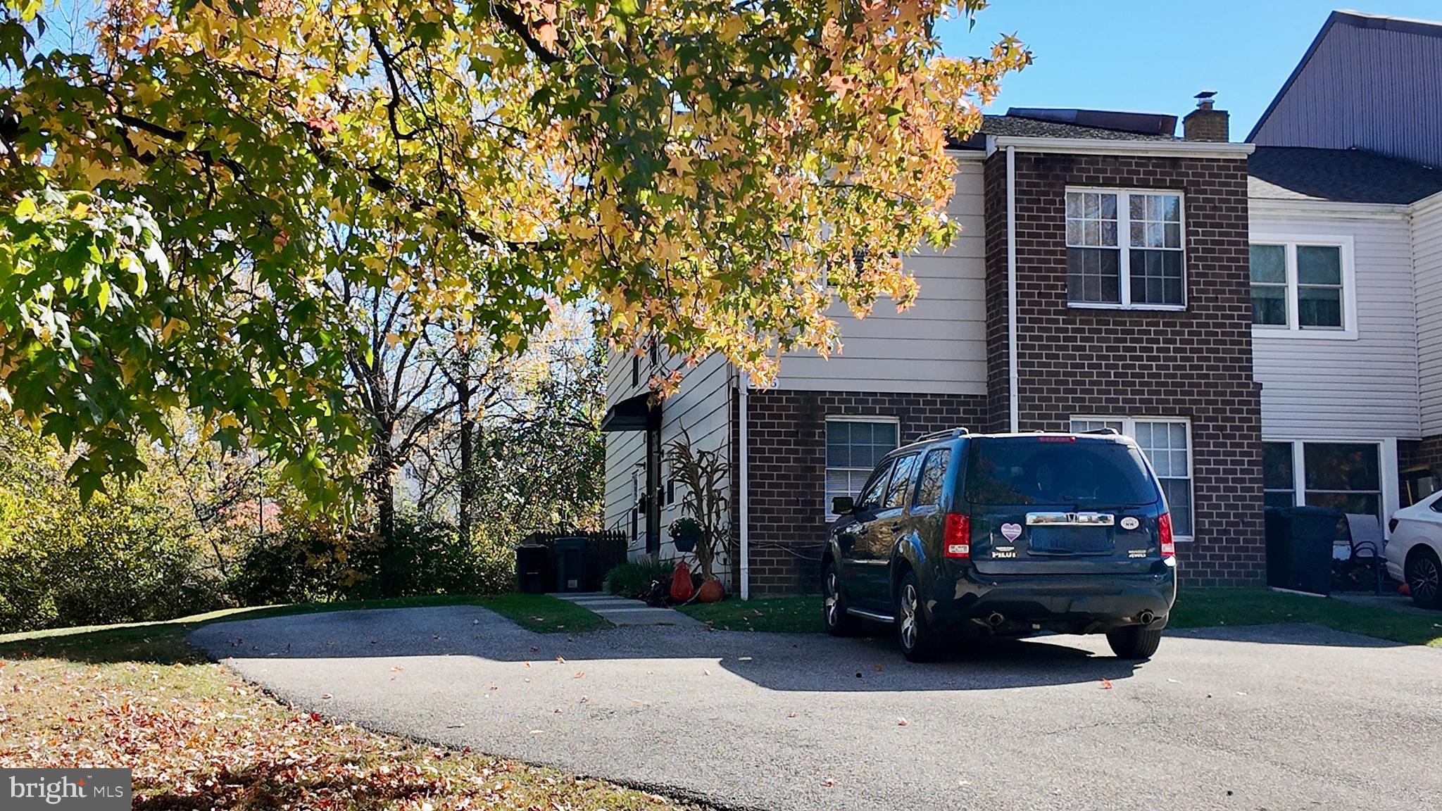 a view of a car parked in front of a house