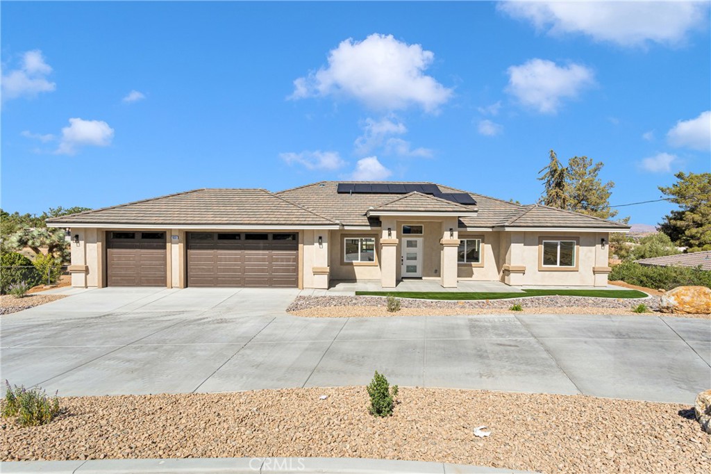 a front view of a house with a garden and yard