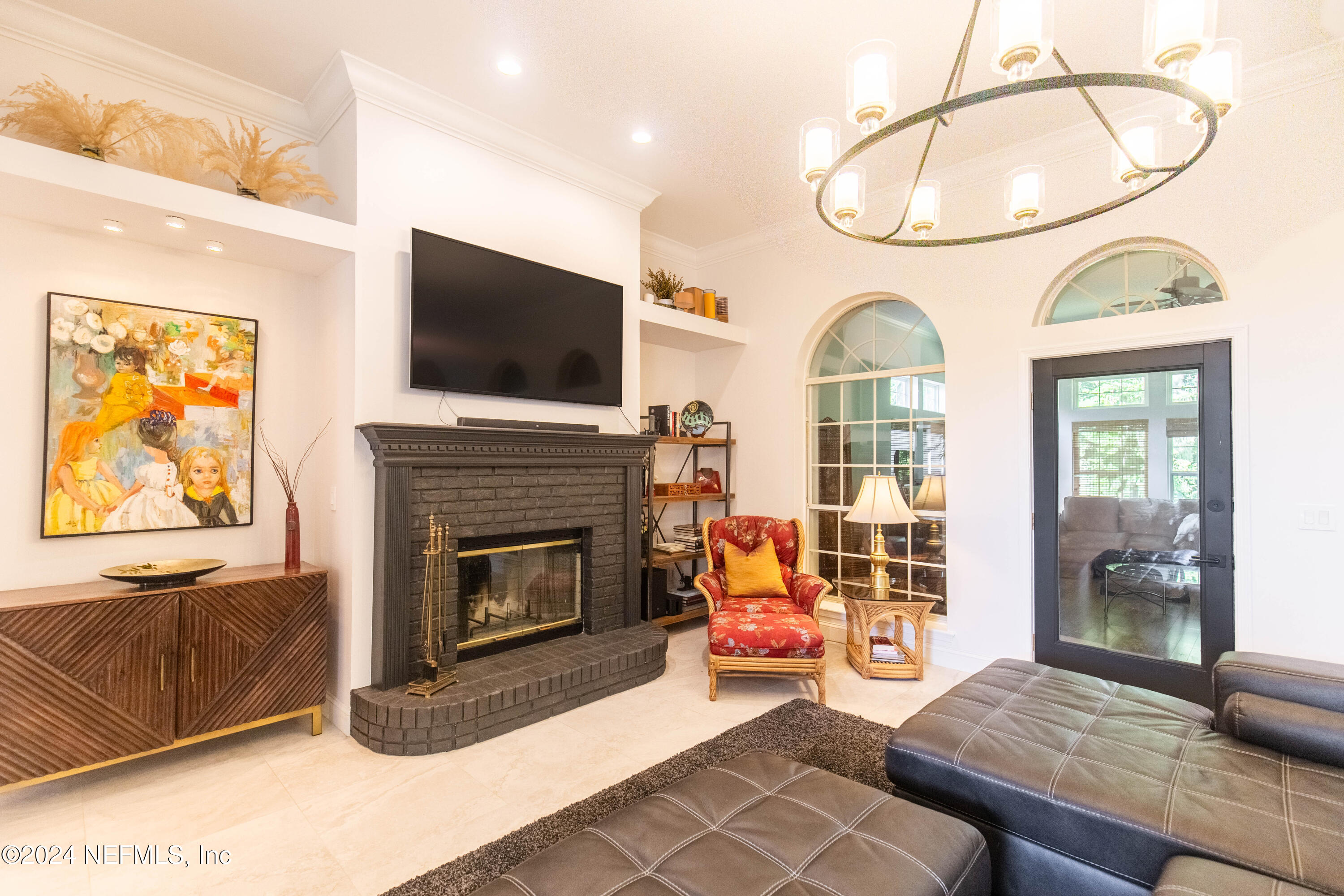 a living room with furniture a flat screen tv and a fireplace