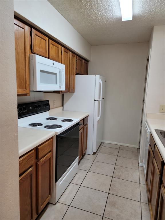 a kitchen with a stove a sink and a refrigerator