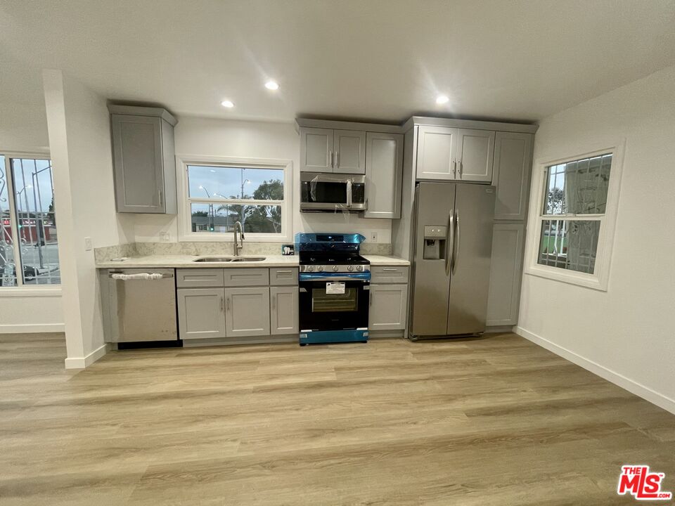 a kitchen with a refrigerator and a stove