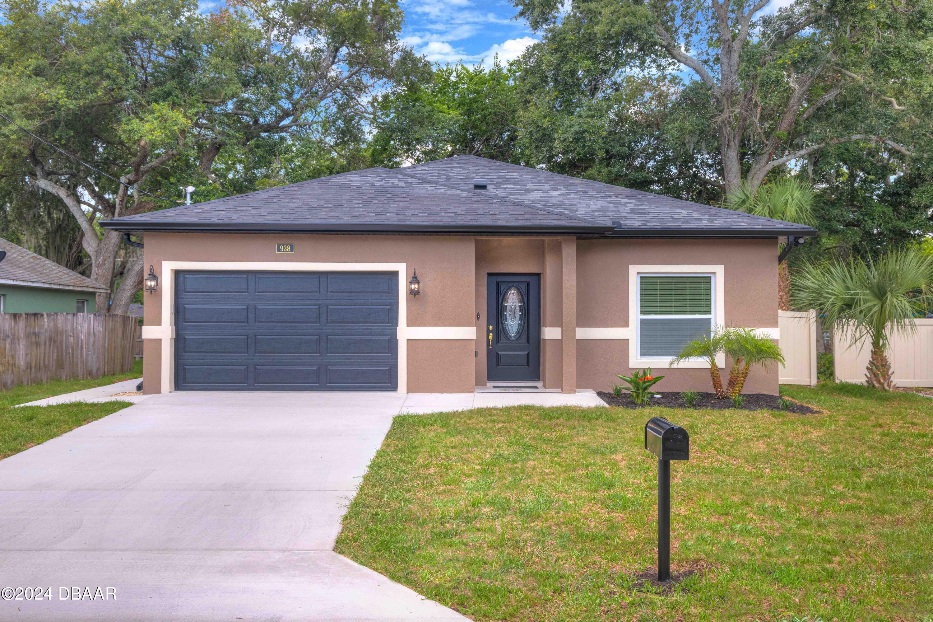 a front view of a house with garden