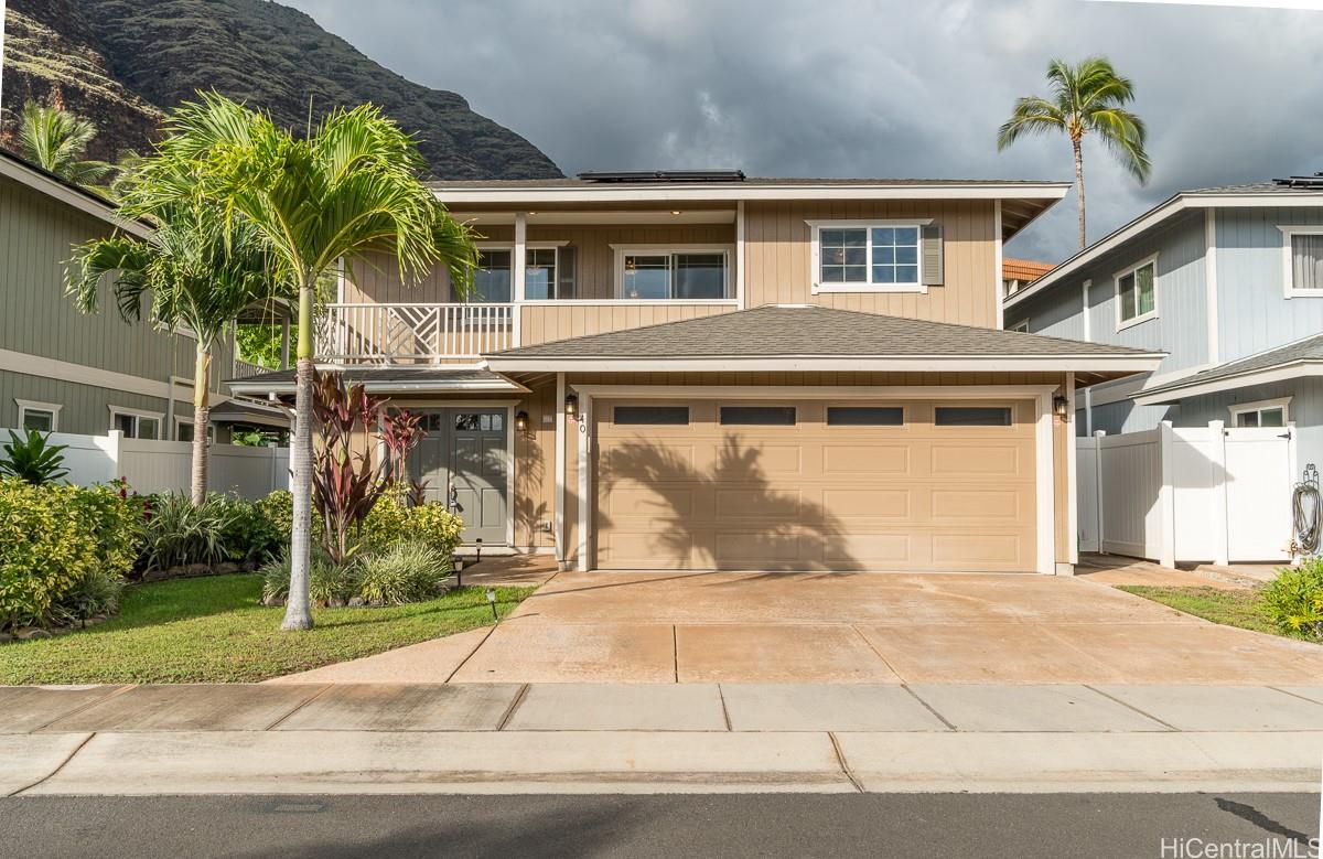 a front view of a house with a yard and a garage