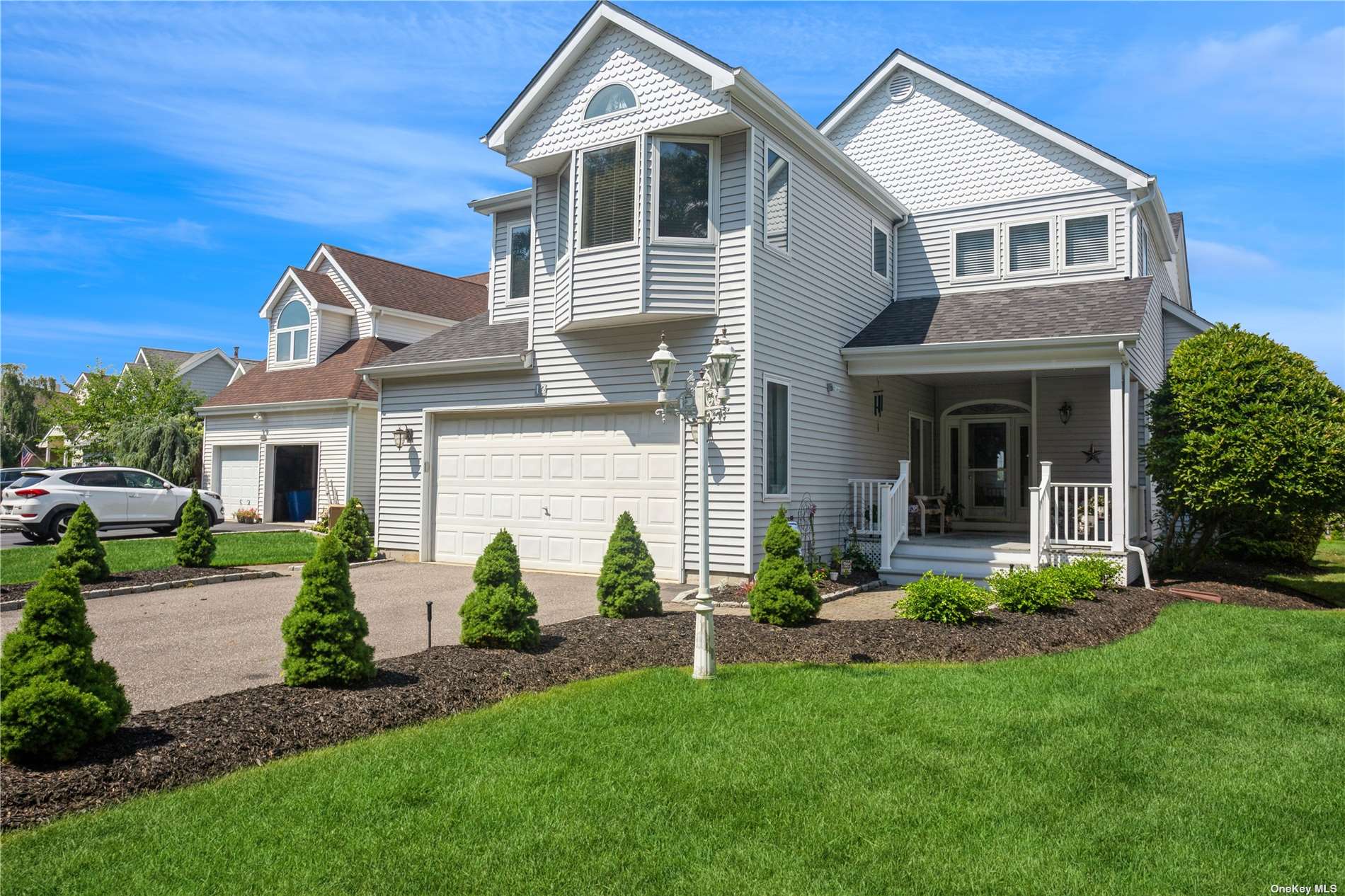 a front view of a house with a garden and plants