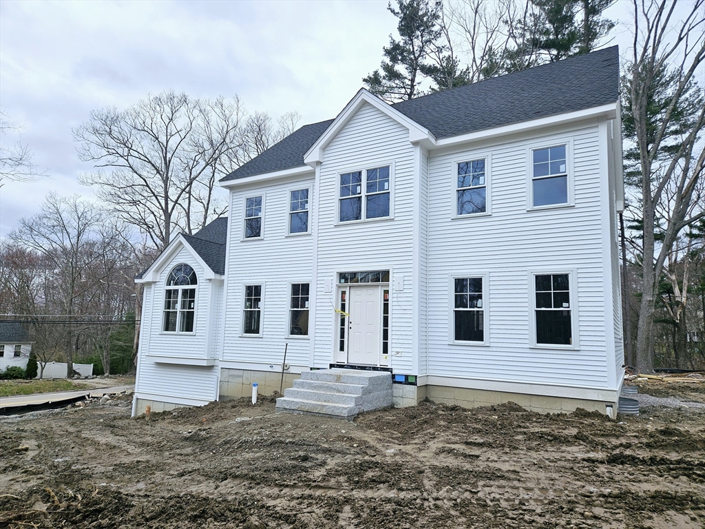 a view of a white house with a yard