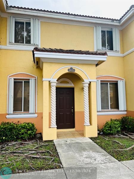 a view of a brick house with many windows