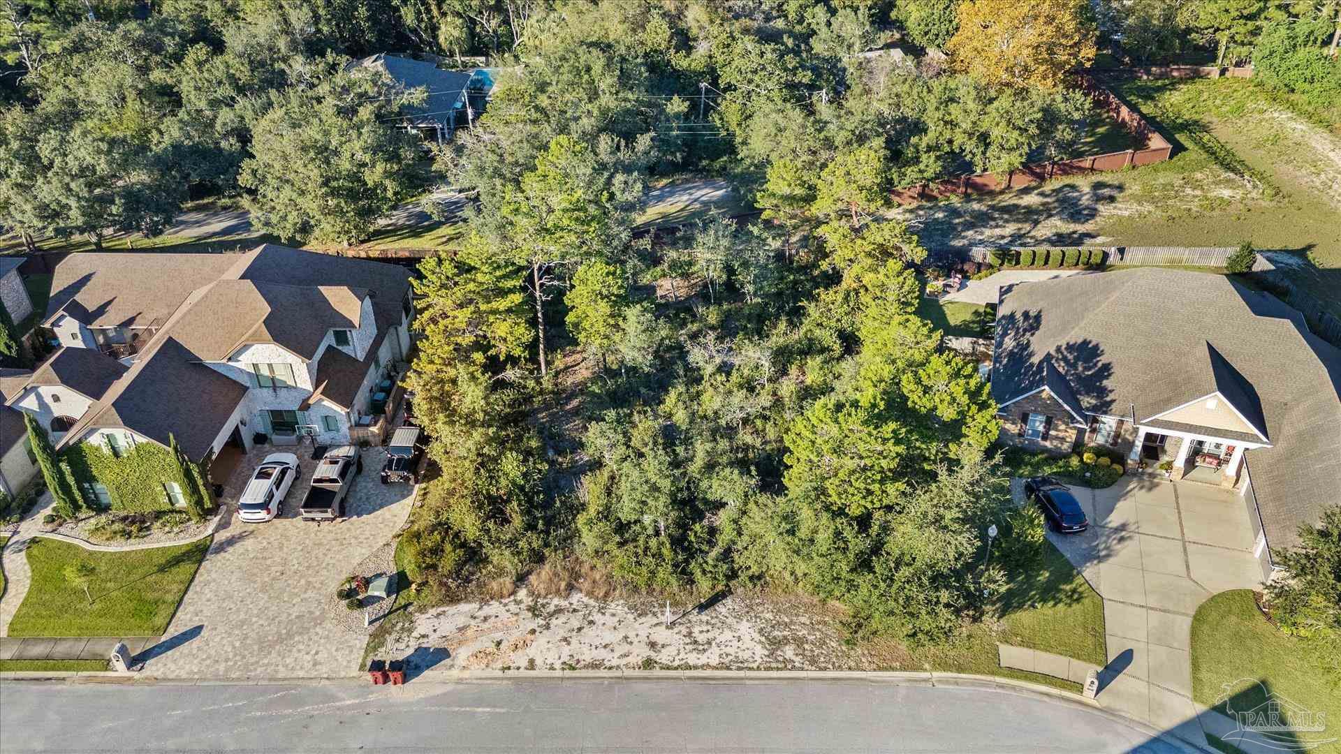 an aerial view of a house with a yard and sitting area