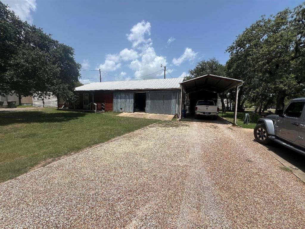 a view of a house with furniture and a yard