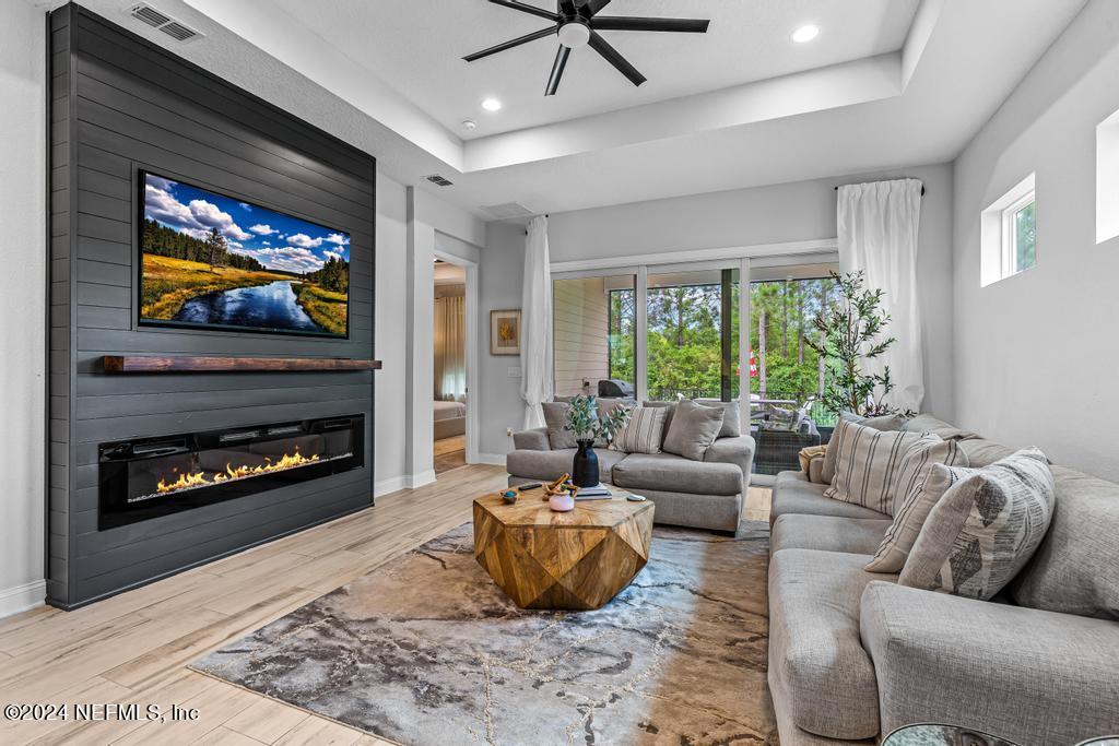 a living room with furniture a fireplace and a flat screen tv