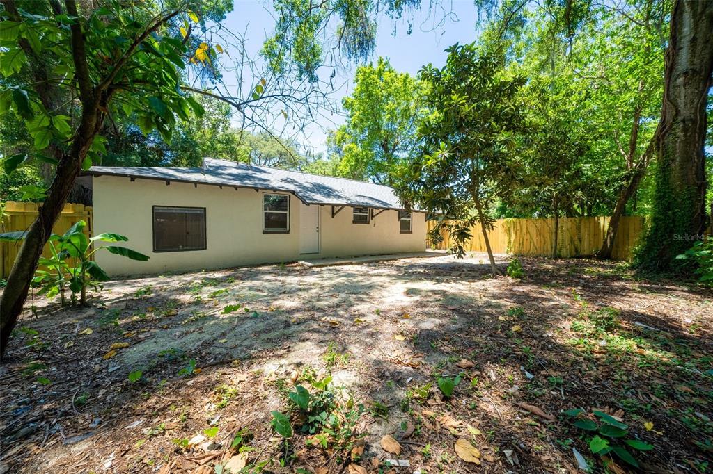 a backyard of a house with table and chairs