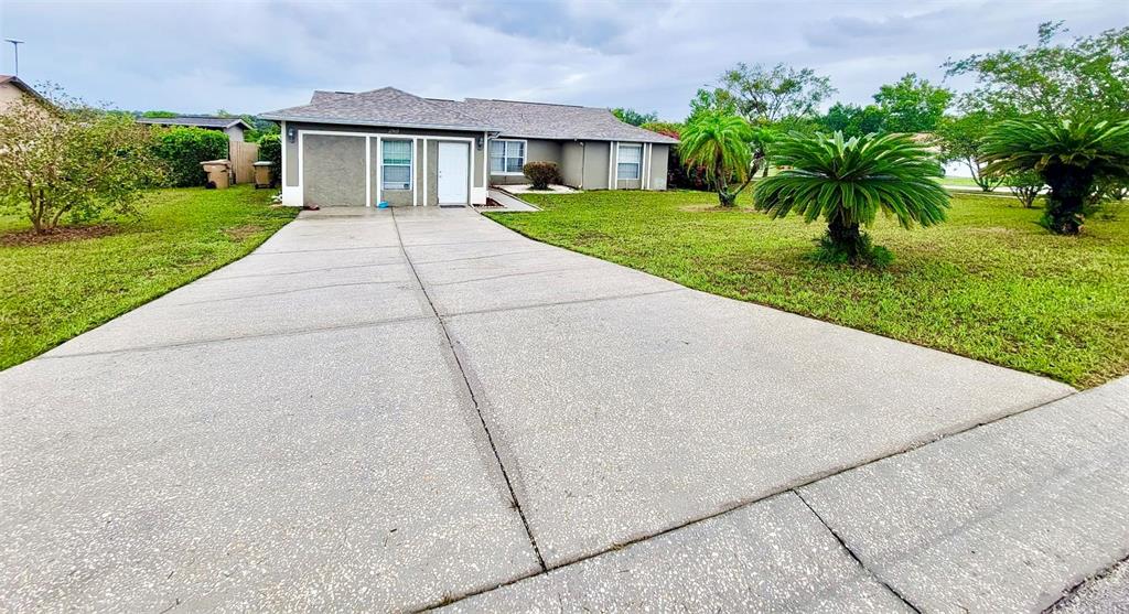 a front view of house with yard and green space