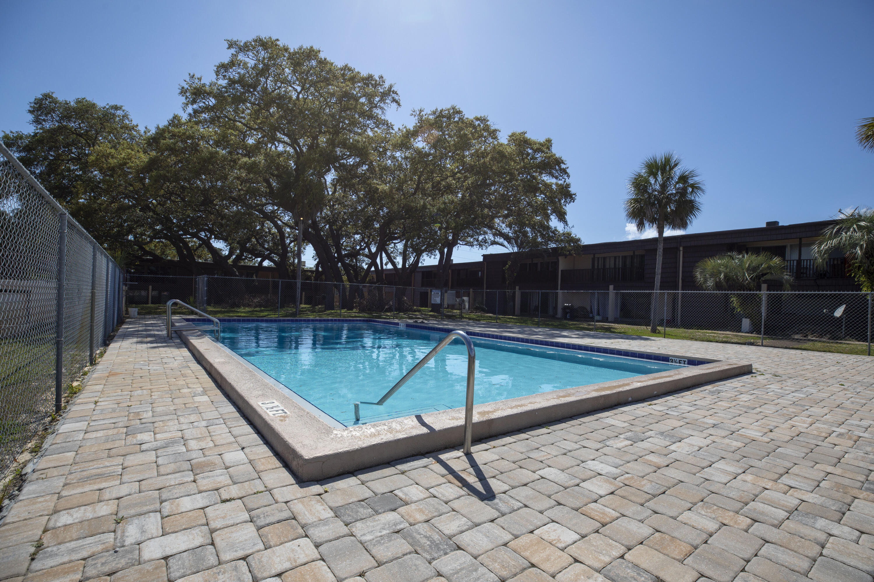 a view of a backyard with swimming pool