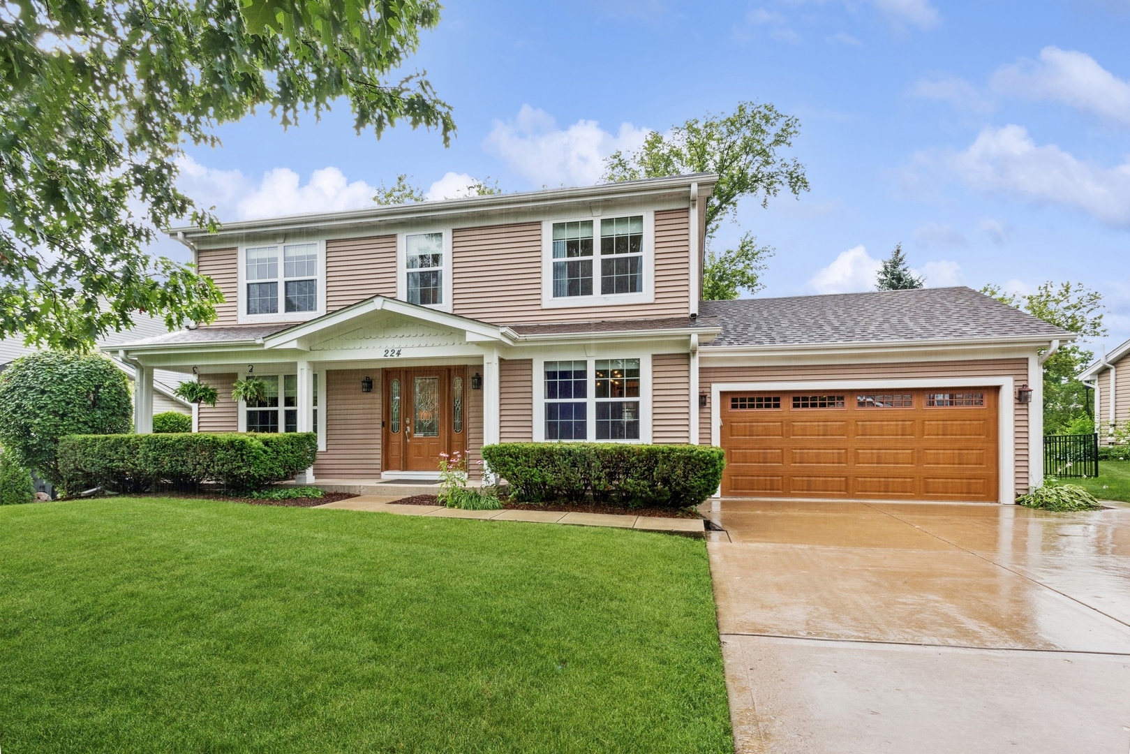 a front view of a house with a yard and garage