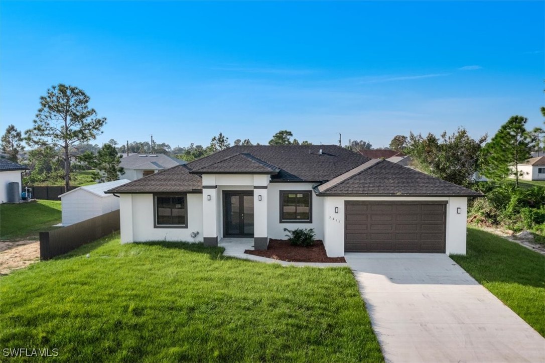 a front view of a house with a yard and garage