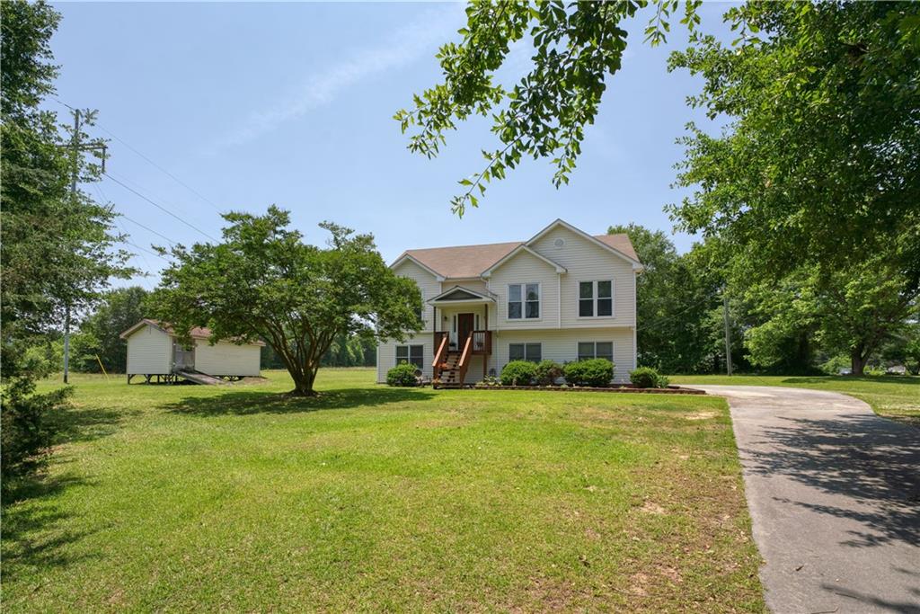 a front view of a house with a garden