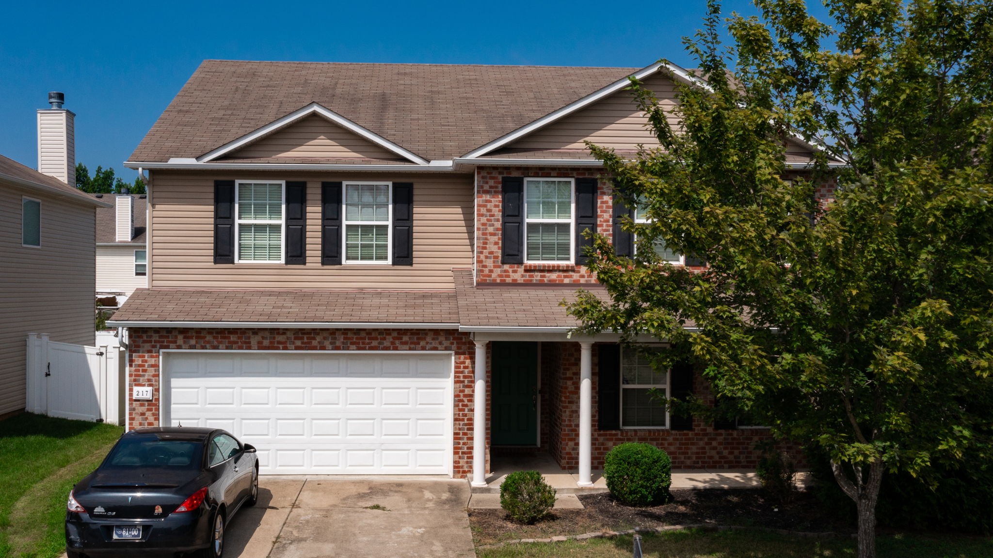 a front view of a house with parking space