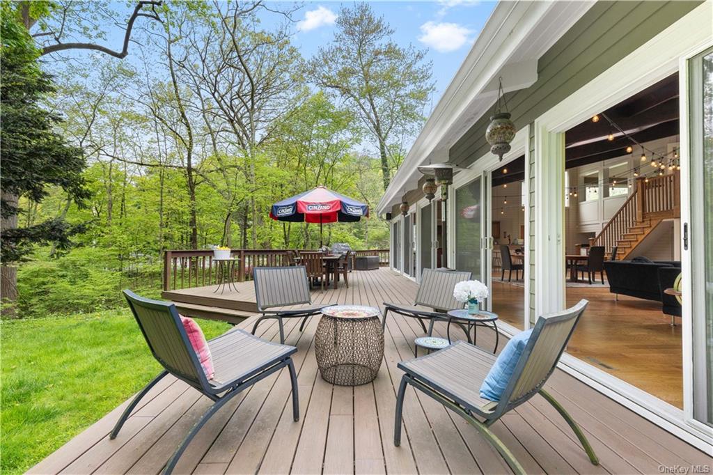 a view of deck with furniture and garden